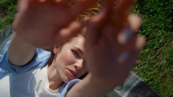 Closeup Woman Hands in Green Grass Background