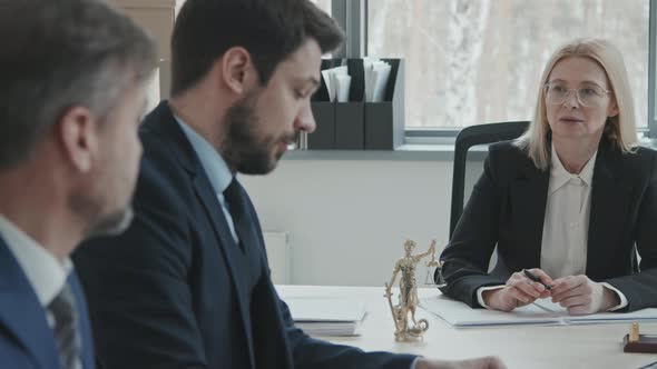 Team of Lawyers Conferencing at Table