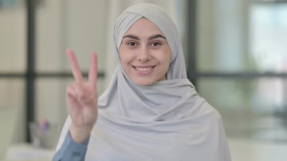 Young Arab Woman Showing Victory Sign