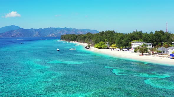 Wide angle drone clean view of a paradise sunny white sand beach and aqua blue water background