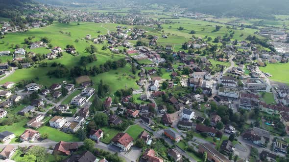 Aerial View of Liechtenstein with Houses on Green Fields in Alps Mountain Valley