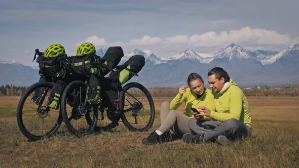 The Man and Woman Travel on Mixed Terrain Cycle Touring with Bikepacking