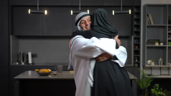 Excited Loving Middle Eastern Husband Hugging Spinning Wife Smiling