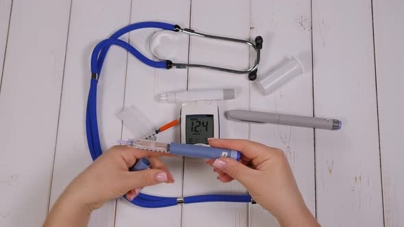 A Diabetic Woman Dials the Right Dose of Insulin on an Insulin Pen