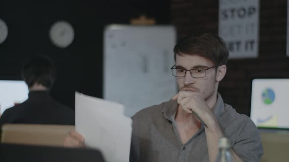 Angry Business Man Throwing Document Paper on Table Front Laptop in Late Office