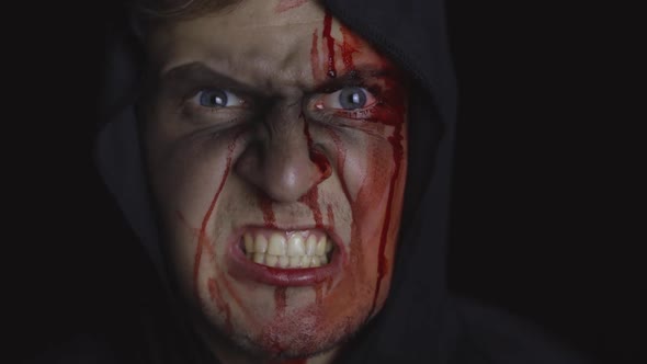 Man Executioner Halloween Makeup and Costume. Guy with Blood on His Face