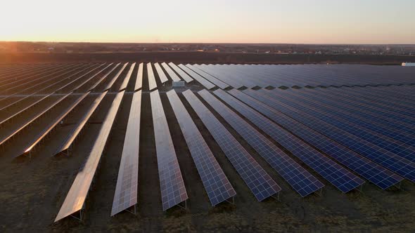 Aerial Drone View of Large Solar Panels at a Solar Farm at Bright Sunset