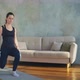 Woman with Weights Does Dynamic Lunges in Living Room - VideoHive Item for Sale