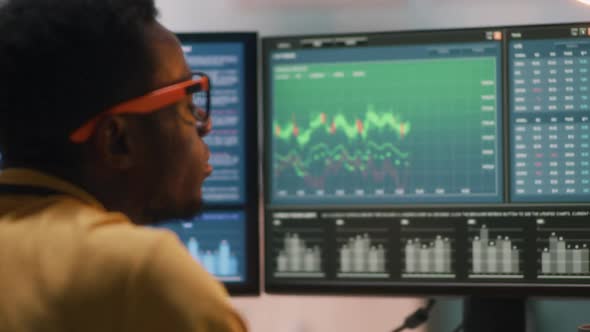 Black Trader Analyzing Financial Data