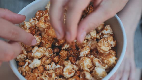 Girl Eating Popcorn on the Street