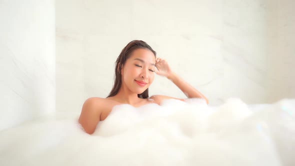 Young asian woman relax in bathtub