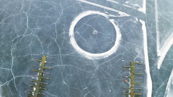 Vik Bathavn Jetty At Steinsfjorden Frozen Lake With Cracked Ice In Norway. - aerial