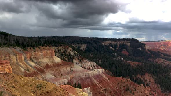 Stormy clouds gathering above a colorful red-rock canyon in the high desert mountains