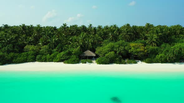 Wide flying island view of a white paradise beach and aqua turquoise water background in vibrant 4K