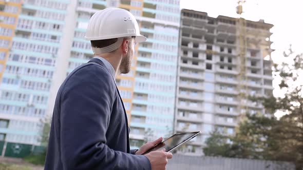 Construction engineer with a tablet in his hands