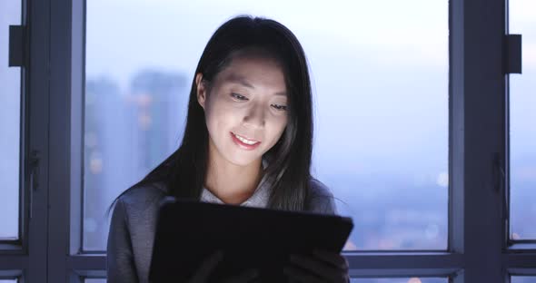 Woman use of tablet computer at night 