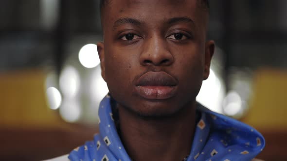 Close Up View of Young Serious Afro American Man Looking to Camera