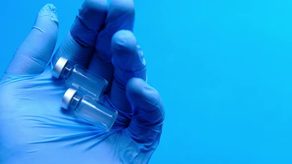 Vaccine and Syringe on Doctor's Hand Top View 