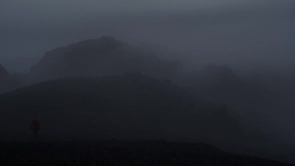 dramatic iceland landscape at night, camera movement, camera pan from right to left to reveal a pers