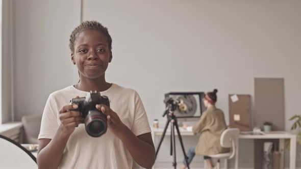 Portrait of Black Female Photographer with Camera