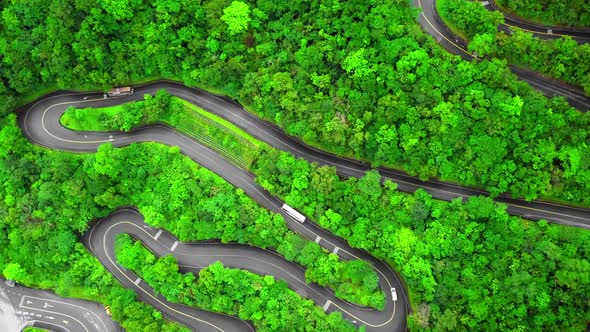 Winding Road with Transport Traffic Among Green Lush Forest Trees in Taroko Gorge National Park