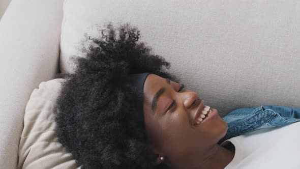 Smiling Attractive Young African American Girl Student Landing on Pillow Enjoying End of Working Day