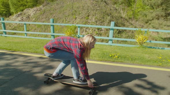 Active Woman Skater Practicing Skateboarding Skills in Public Park