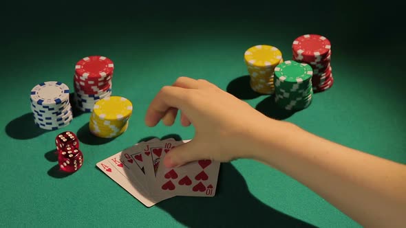 Lucky Gambler Showing Down Royal Flush Hand, Poker Player Wins Bank in Casino