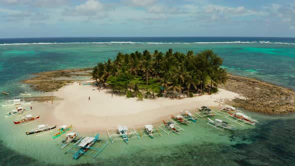 Tropical Guyam Island with a Sandy Beach and Tourists