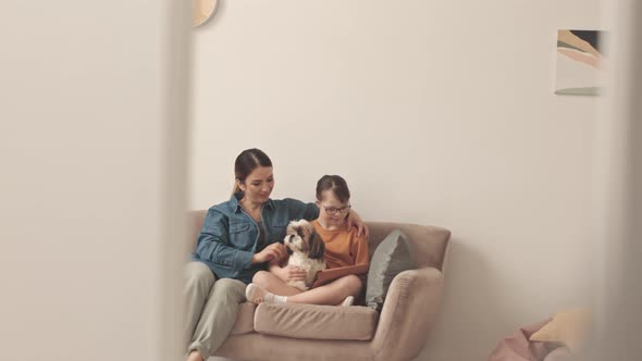 Woman and Little Girl with Down Syndrome on Sofa with Dog