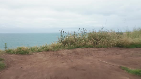  Drone Flying Through the Yellow Camping Tent on the Edge of Ocean Cliff, USA