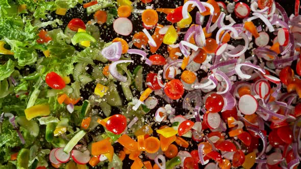 Super Slow Motion Shot of Flying Cuts of Colorful Fresh Vegetables and Water Drops at 1000Fps.