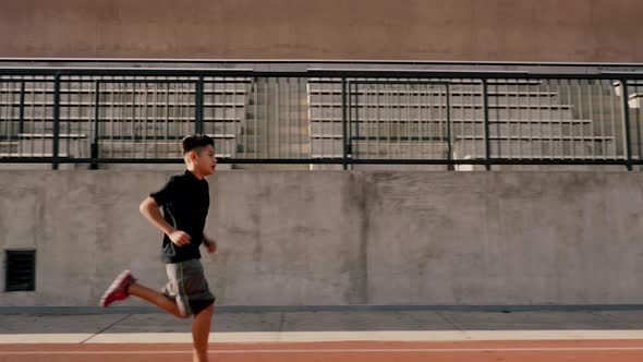 Boy Running On School Track