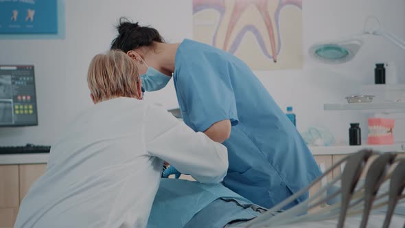 Dentistry Team Doing Teeth Extraction on Patient with Toothache