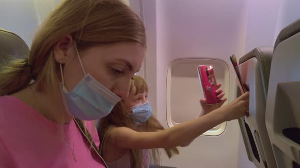 Woman And Girl With Phone On The Plane