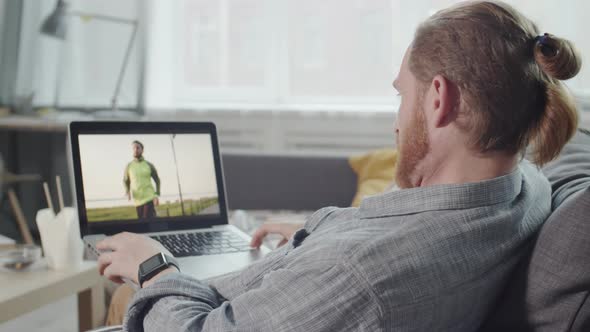 Man Watching Videos on Laptop