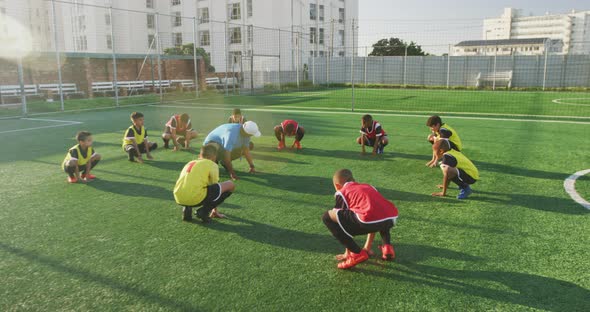 Soccer kids exercising in a sunny day