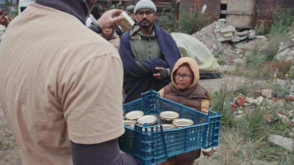 Refugees Taking Tinned Food from Volunteers