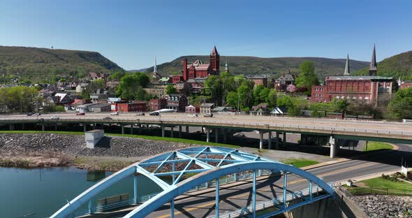 Cumberland Maryland. Rising aerial reveal from river to Interstate 68 to Haystack Mountain. Famous c