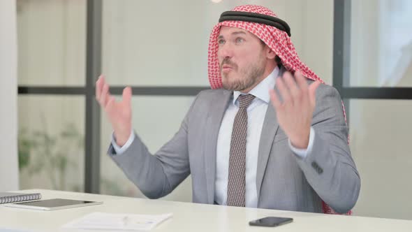 Upset Middle Aged Arab Businessman Feeling Worried While Sitting in Office