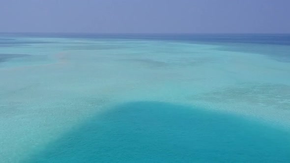 Aerial drone abstract of resort beach break by lagoon with sand background