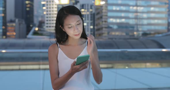 Woman use of mobile phone at night 