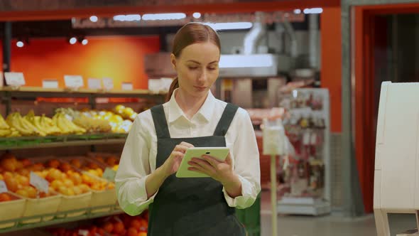 Young Store Manager Types Information About Greengroceries