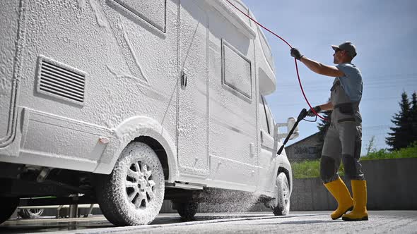 Men Washing Modern Class C Camper Van RV with Active Foam