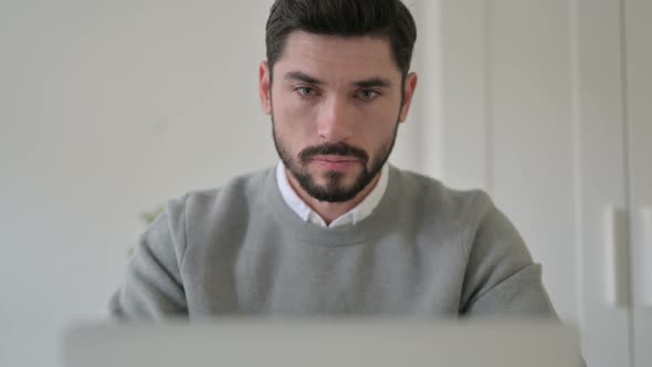 Close Up of Man Feeling Shocked While Using Laptop