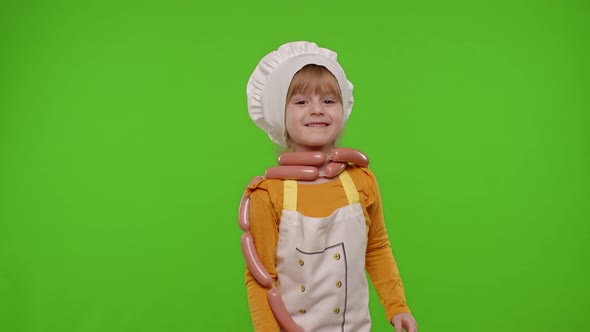 Child Girl Kid As Cook Chef Stay with Sausages Fooling Around Making Faces Showing Thumbs Up