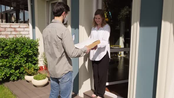 Man in Face Mask and Gloves Delivering Packages