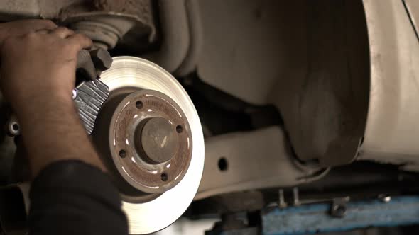 Replacing Old Brake Discs Of A Car In A Repair Shop 3