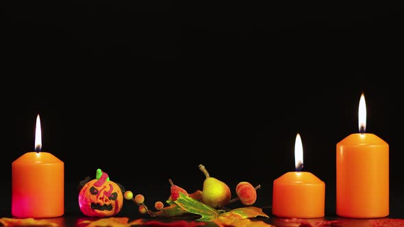 Burning Yellow Candles and a Creepy Pumpkin Halloween Greetings