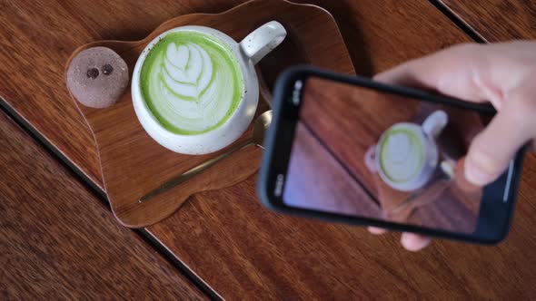 Food Blogger Filming on Phone Hot Matcha Latte for New Content in Social Media Online Digital